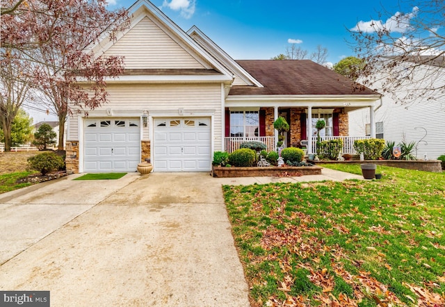 view of front of property with a porch, a garage, and a front yard