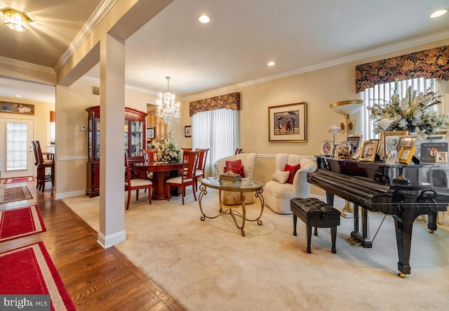 interior space with a chandelier, ornamental molding, hardwood / wood-style flooring, and a healthy amount of sunlight