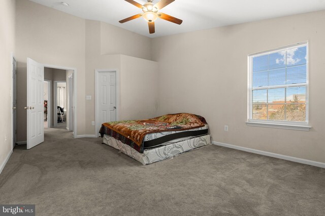 bedroom with carpet floors, vaulted ceiling, and ceiling fan