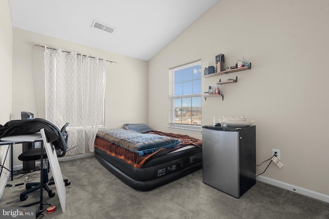 carpeted bedroom featuring refrigerator and lofted ceiling