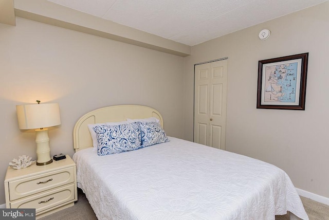 carpeted bedroom featuring a closet