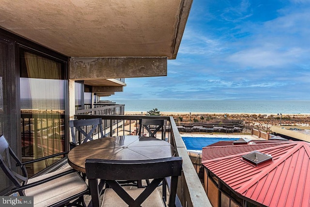 balcony with a view of the beach and a water view