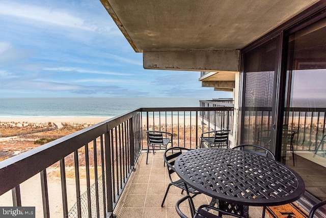 balcony featuring a water view and a view of the beach