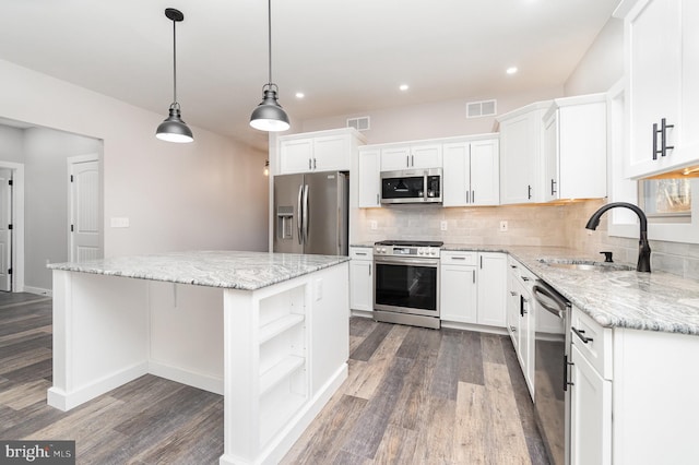 107 S Honeysuckle Dr, Hazle Township, PA 18202 - kitchen featuring appliances with stainless steel finishes, a center island, open shelves, dark wood-style flooring, and white cabinetry