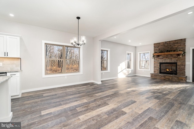 107 S Honeysuckle Dr, Hazle Township, PA 18202 - unfurnished living room with wood finished floors, a fireplace, a chandelier, and recessed lighting