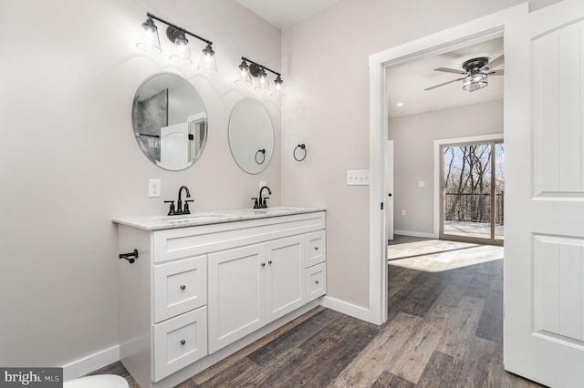 107 S Honeysuckle Dr, Hazle Township, PA 18202 - bathroom with double vanity, wood finished floors, and a ceiling fan