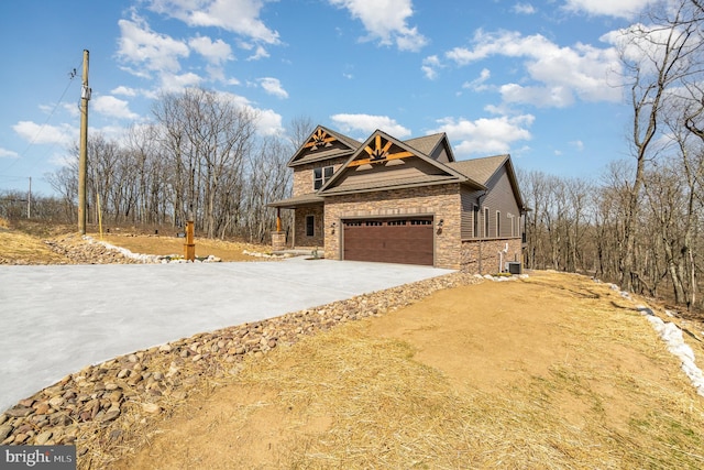 107 S Honeysuckle Dr, Hazle Township, PA 18202 - view of side of property with stone siding, driveway, and a garage