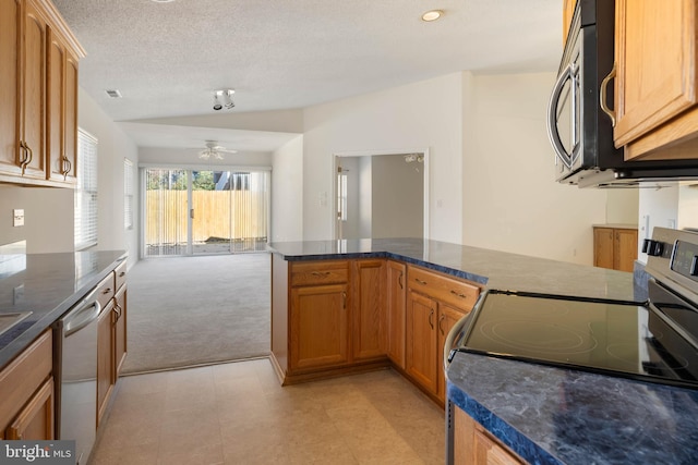 kitchen with ceiling fan, stainless steel appliances, a textured ceiling, and light carpet