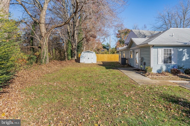 view of yard with cooling unit and a storage shed