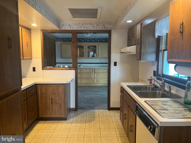 kitchen with sink, white dishwasher, and light wood-type flooring