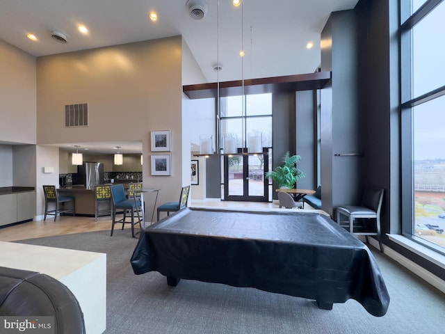 recreation room with carpet flooring, billiards, and a high ceiling