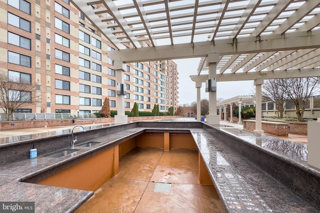 view of patio with a pergola, area for grilling, and sink