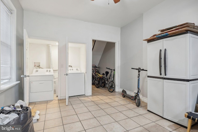 laundry room with light tile patterned floors, washer / dryer, and ceiling fan