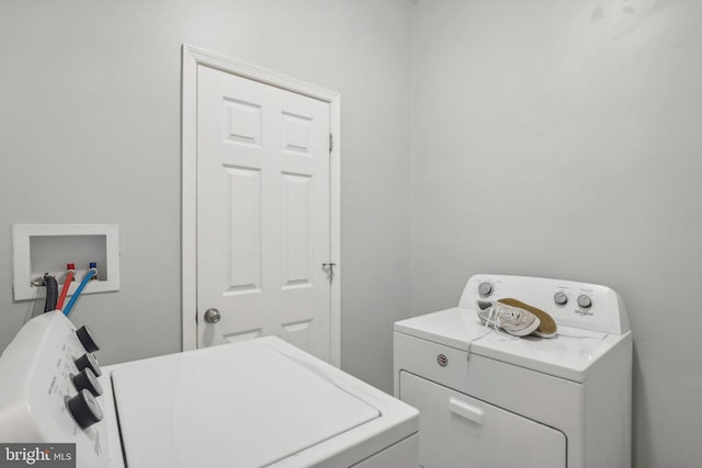 laundry area with independent washer and dryer