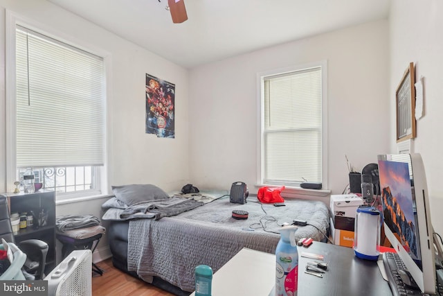 bedroom with hardwood / wood-style floors and ceiling fan