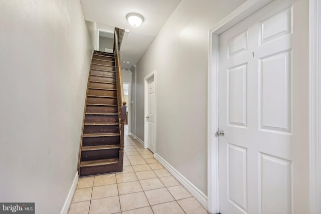 stairs featuring tile patterned flooring