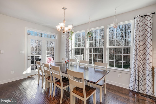 dining space featuring a chandelier and dark wood-type flooring