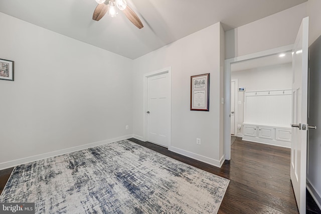 empty room with ceiling fan and dark hardwood / wood-style flooring