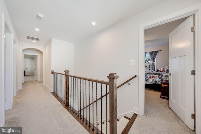 hallway featuring light carpet