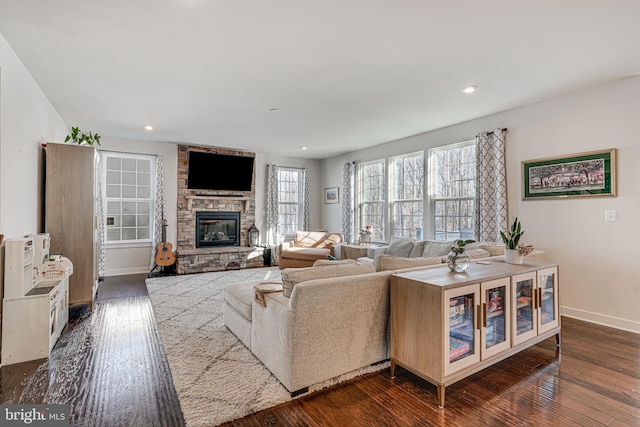 living room with a fireplace and dark wood-type flooring