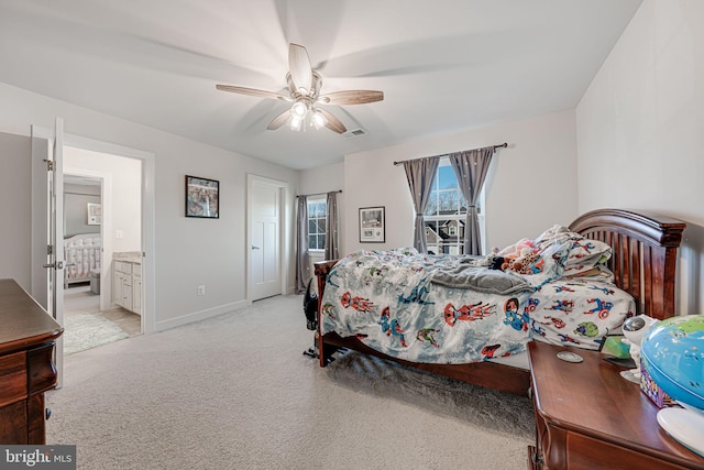 carpeted bedroom featuring ensuite bath and ceiling fan