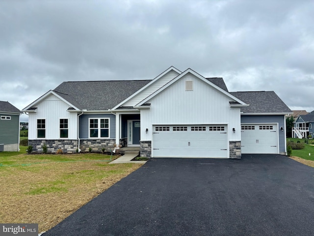 view of front of home featuring a garage and a front lawn