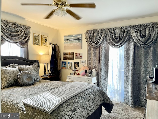 bedroom with ceiling fan and carpet floors