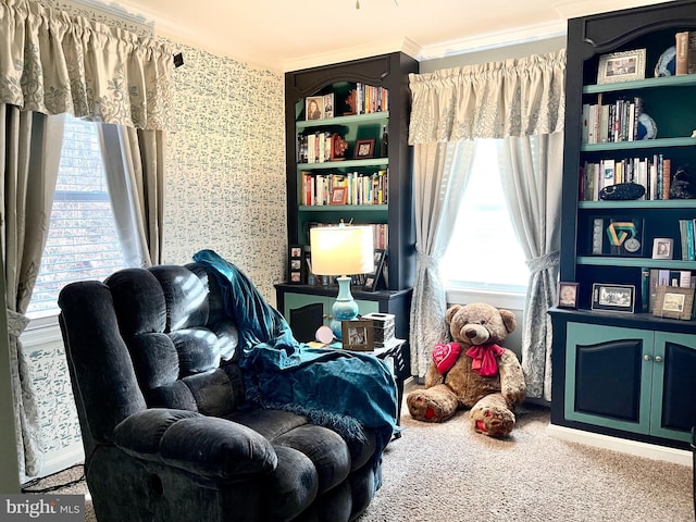 sitting room with carpet floors and ornamental molding