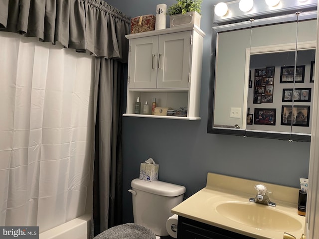 full bathroom with vanity, shower / bath combination with curtain, and toilet