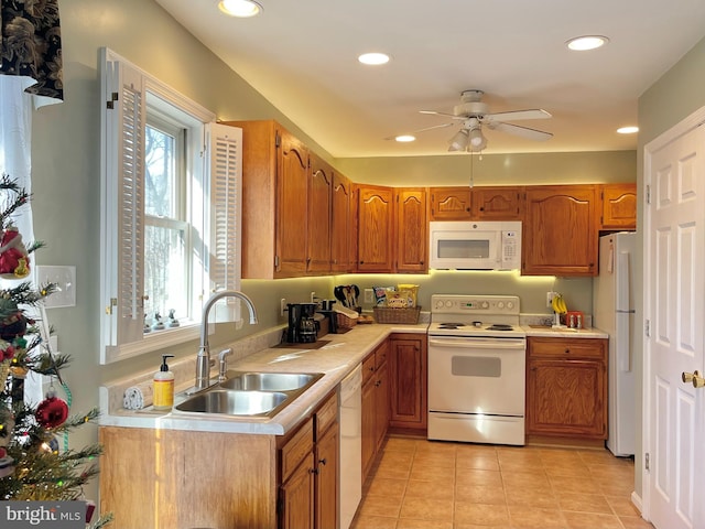 kitchen featuring ceiling fan, sink, light tile patterned flooring, and white appliances