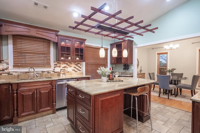 kitchen featuring dishwasher, a center island, sink, decorative light fixtures, and a notable chandelier