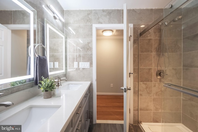 bathroom featuring hardwood / wood-style floors, vanity, and a shower with shower door