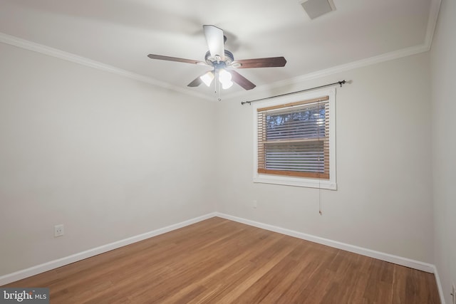 empty room with crown molding, hardwood / wood-style floors, and ceiling fan