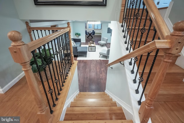 stairs with hardwood / wood-style flooring