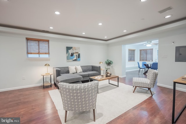 living room with hardwood / wood-style floors, electric panel, and ceiling fan