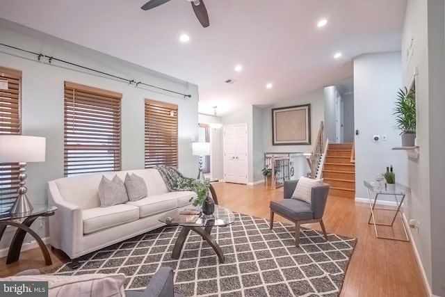 living room featuring hardwood / wood-style flooring and ceiling fan