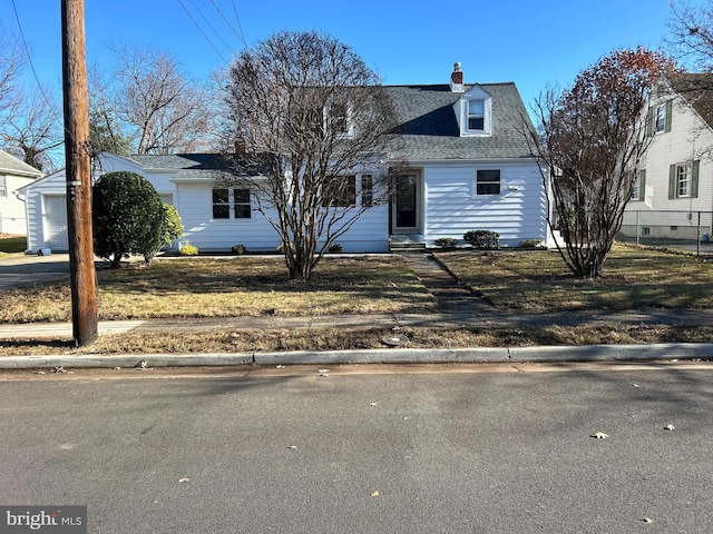 new england style home with a garage