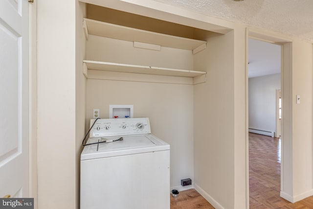 laundry room featuring light parquet floors, a textured ceiling, washer / clothes dryer, and a baseboard heating unit