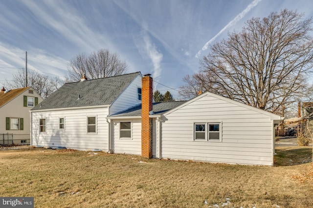 rear view of house with a yard