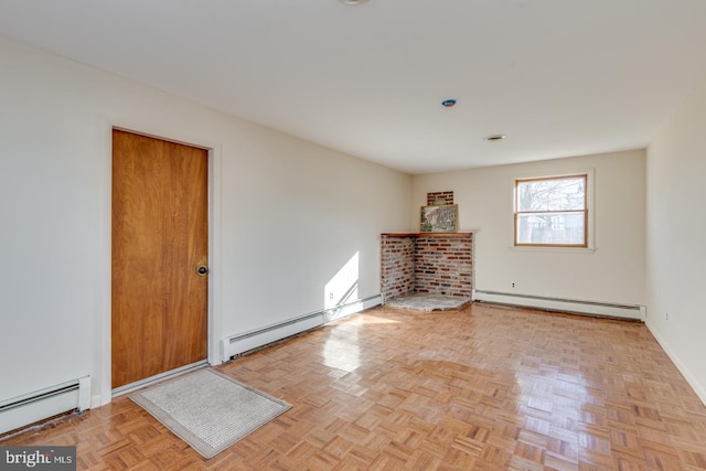 spare room with light parquet flooring and a baseboard heating unit