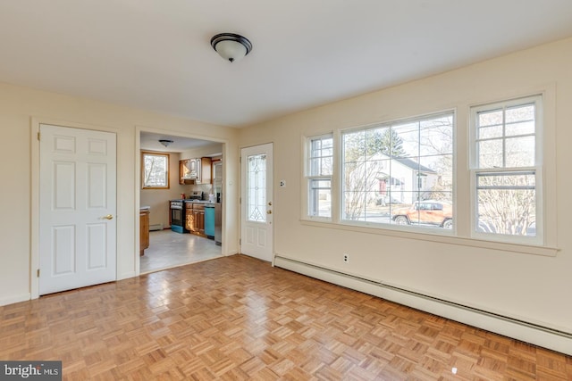 foyer entrance with baseboard heating and light parquet flooring