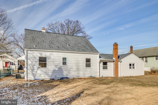 back of house with a yard and cooling unit