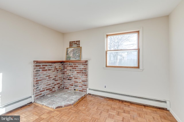 unfurnished room with light parquet floors and a baseboard radiator