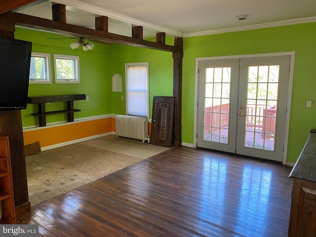 unfurnished living room featuring ceiling fan, radiator heating unit, crown molding, and hardwood / wood-style flooring