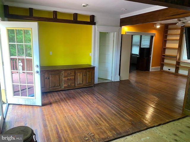 unfurnished room with crown molding and dark wood-type flooring