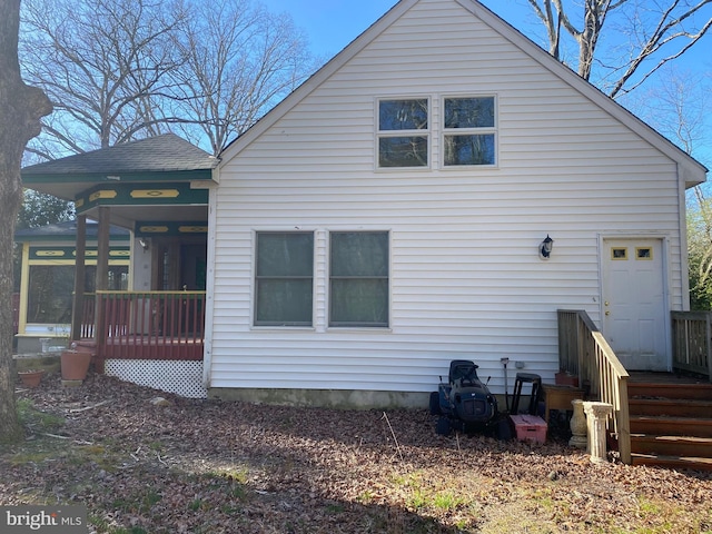 back of property with a sunroom