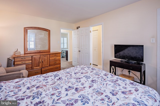 bedroom featuring light colored carpet