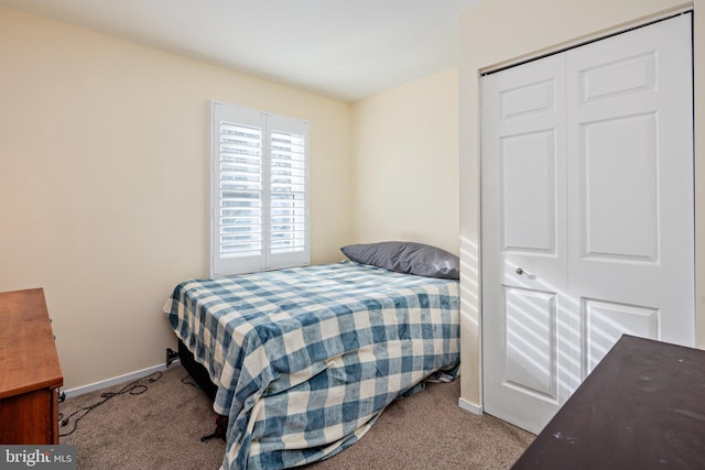 bedroom with a closet and light colored carpet