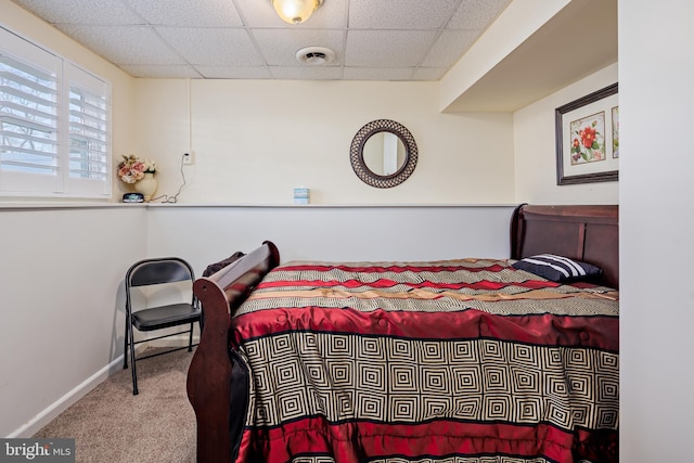 carpeted bedroom featuring a paneled ceiling