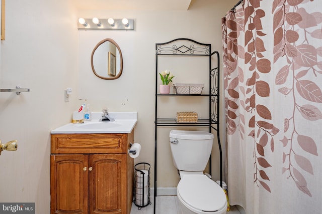 bathroom featuring walk in shower, tile patterned flooring, vanity, and toilet